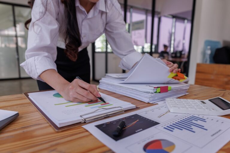Business,Colleagues,Reviewing,Financial,Documents,And,Calculating,Taxes